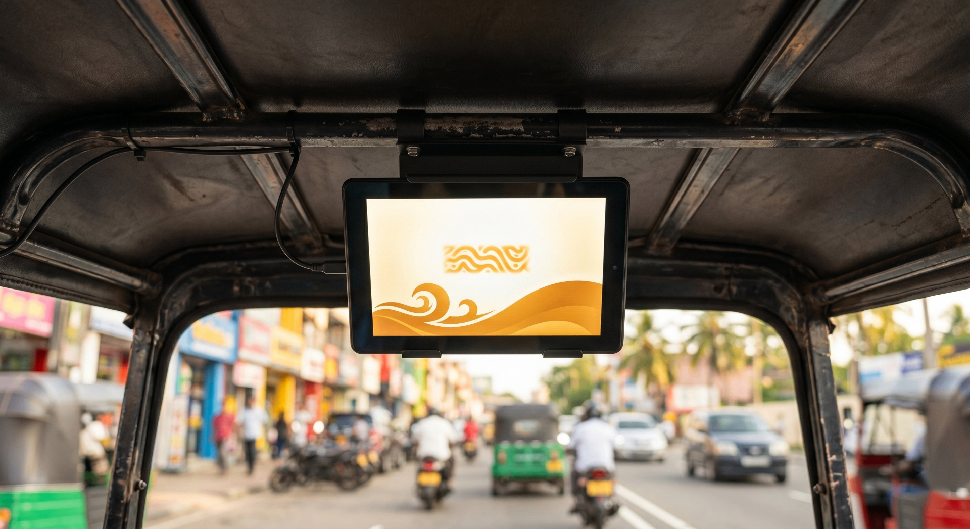 Installed tuk-tuk screen displaying an amber and cream advertisement on a Colombo street